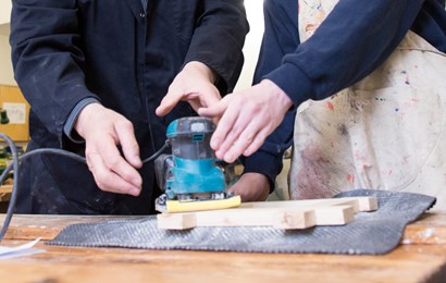 Young person using tool with supervision