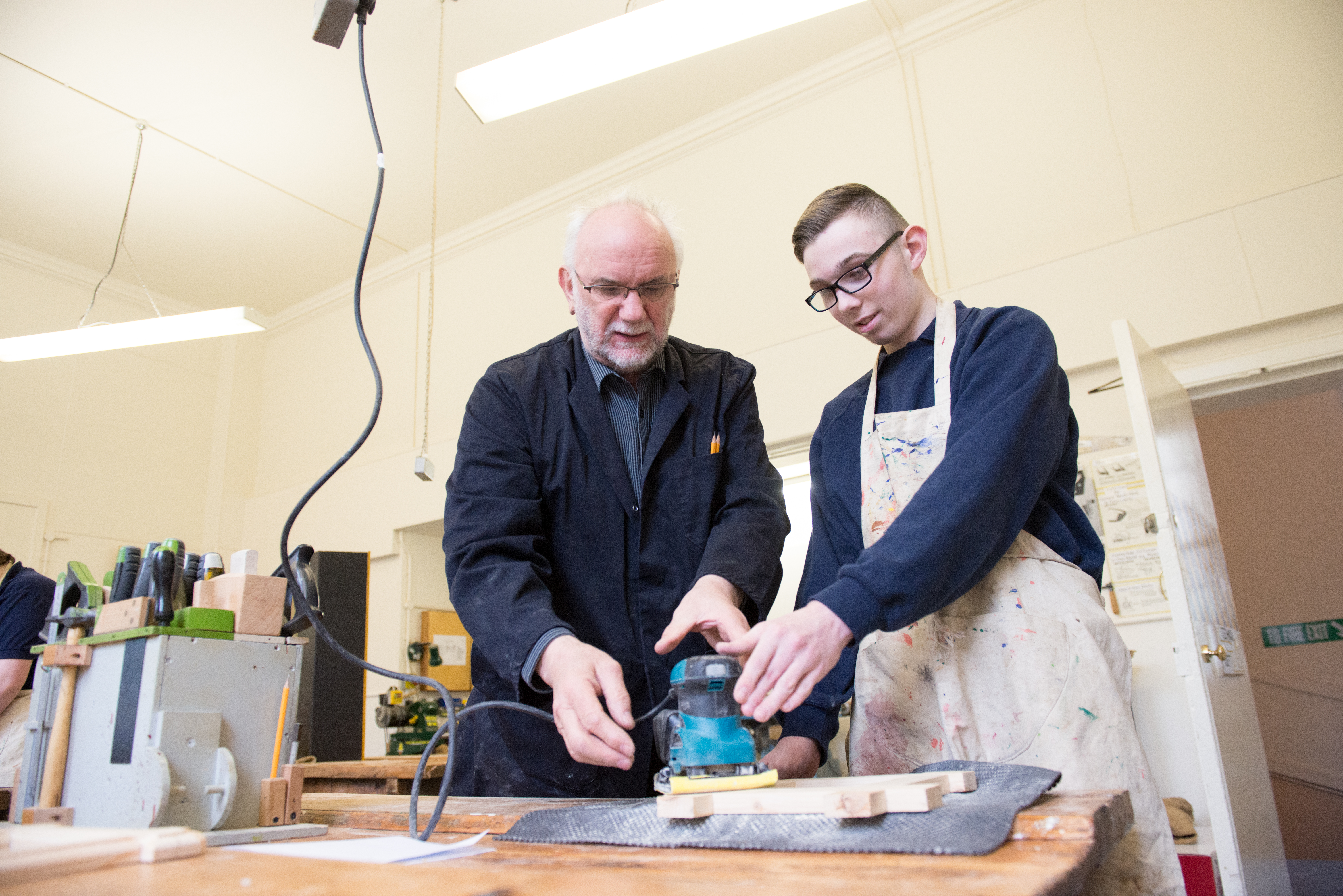 Young person using tool with supervision