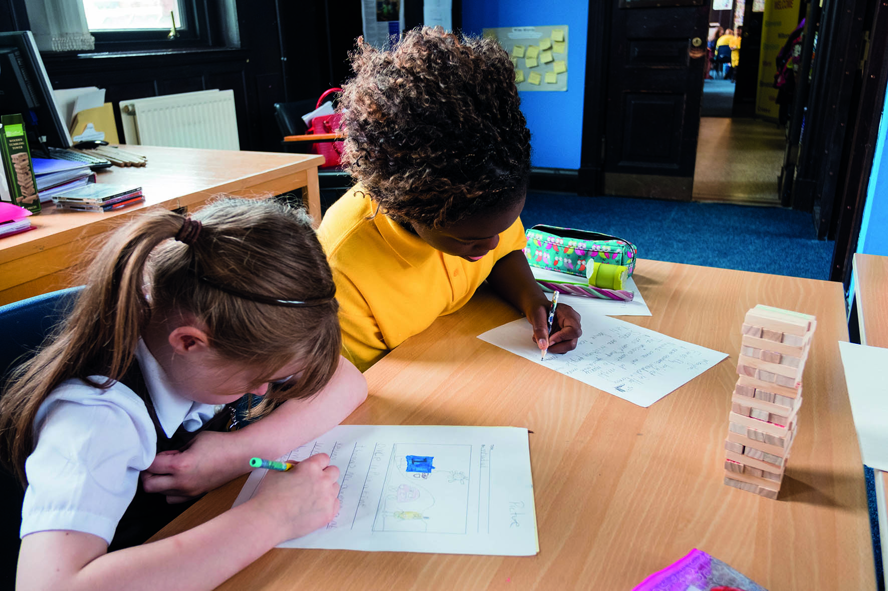 School-aged children writing
