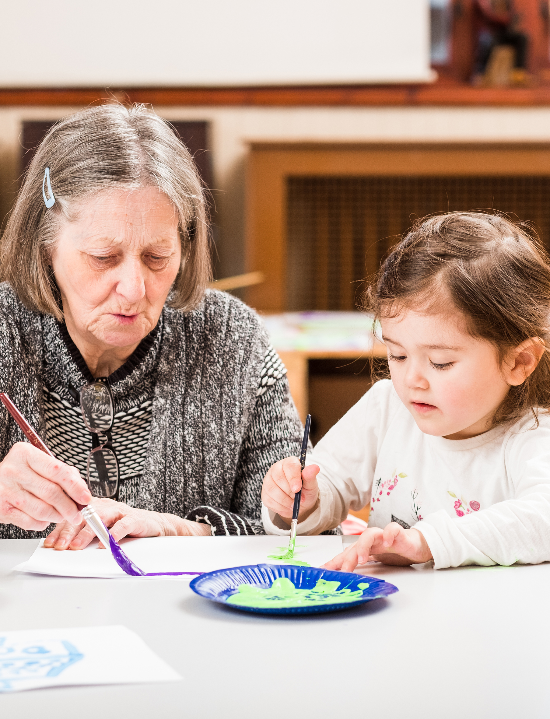 Older lady and young girl painting