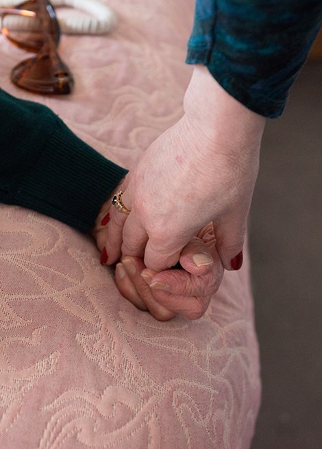 Two people holding hands