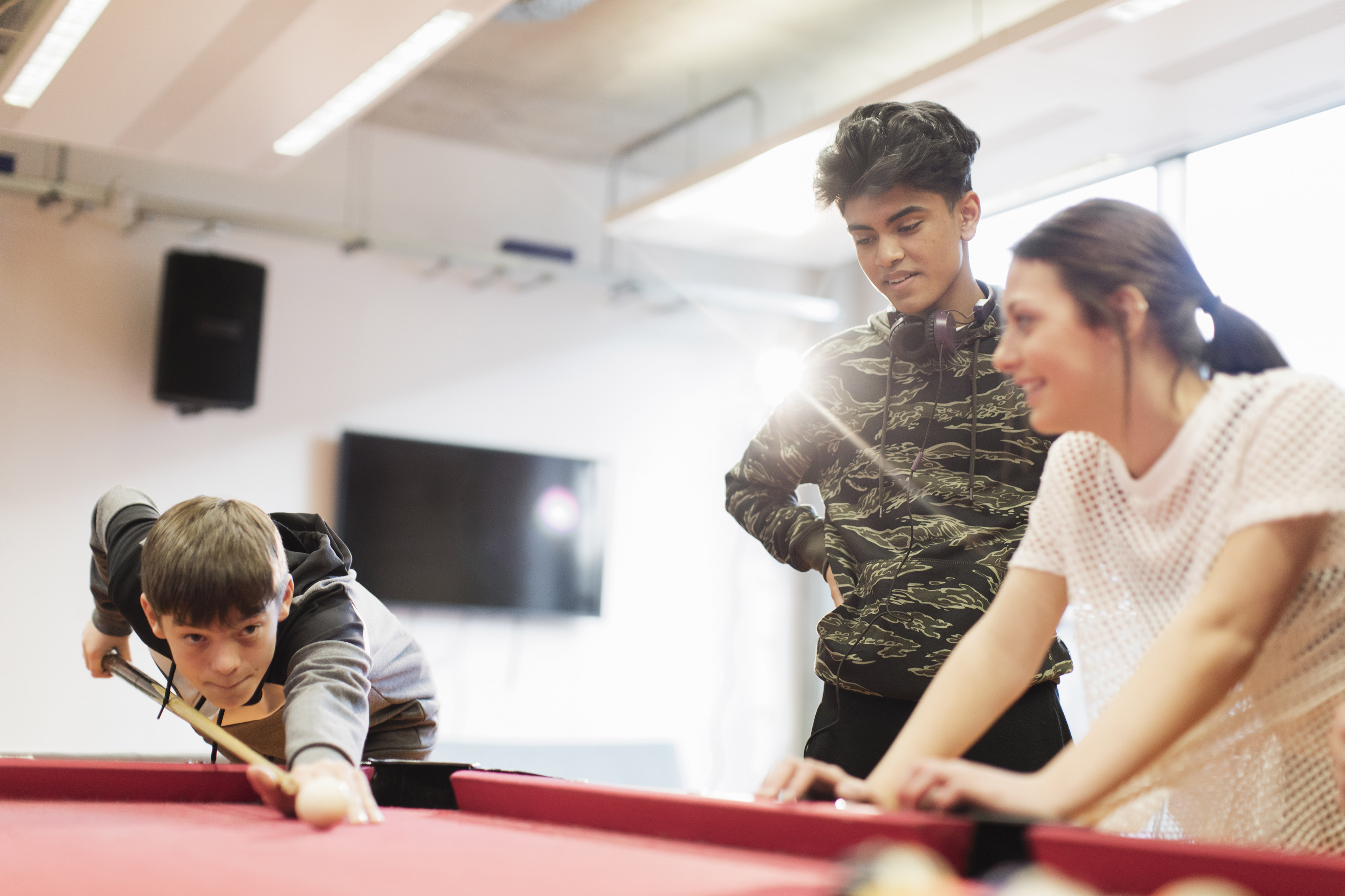 Young people playing pool.