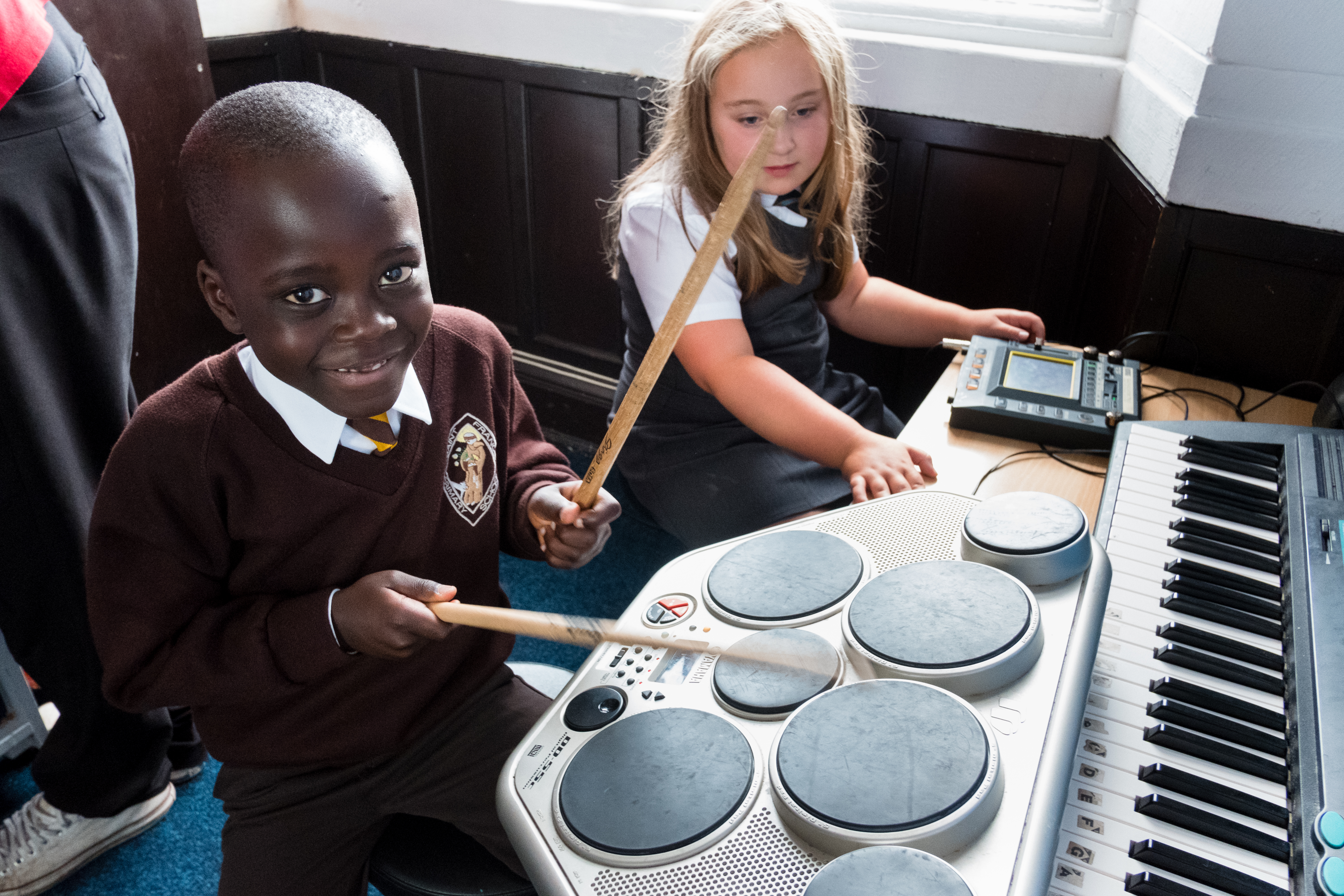 School-aged children playing the drums