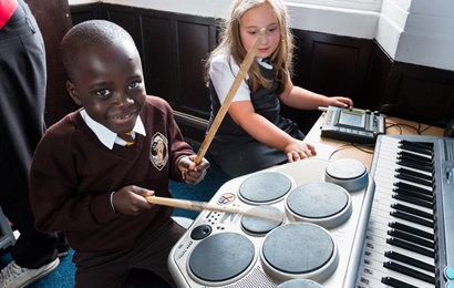 School-aged children playing the drums