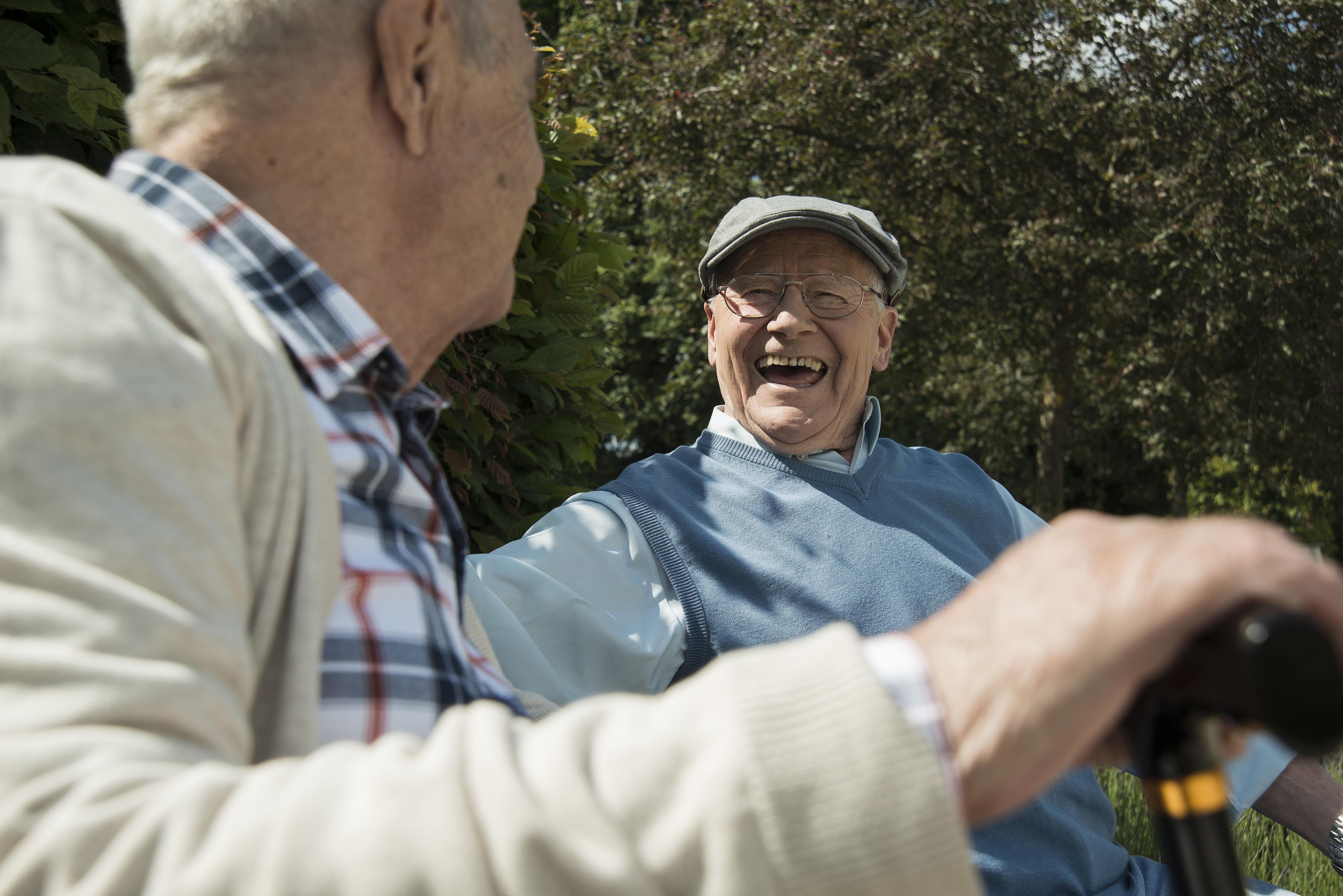 Older people laughing outside