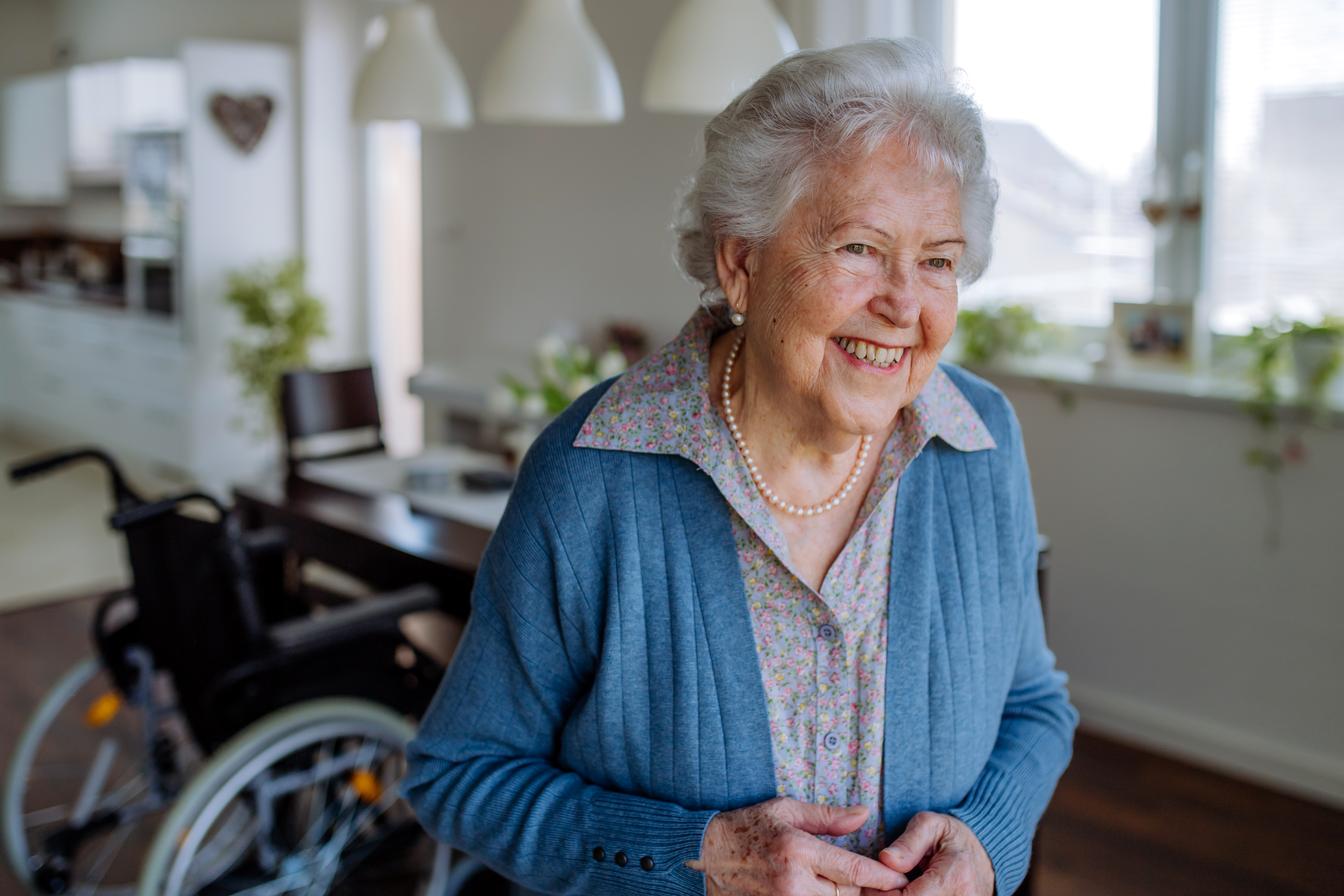 portrait-of-smiling-senior-woman-in-her-home-2023-11-27-04-52-39-utc