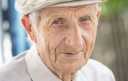 Portrait of an elderly man wearing a bonnet