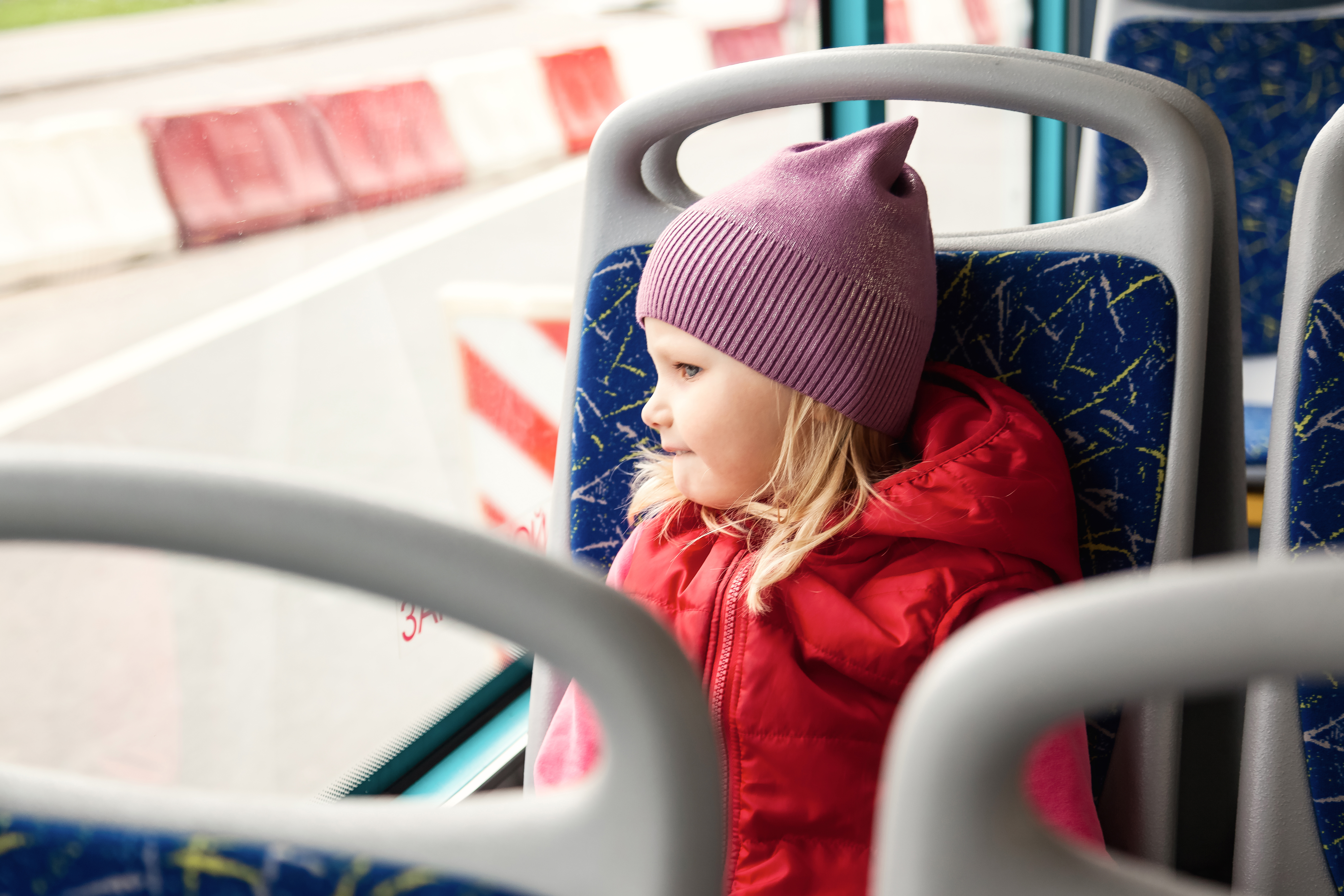 Child Rides Bus At Window Of Public Transport