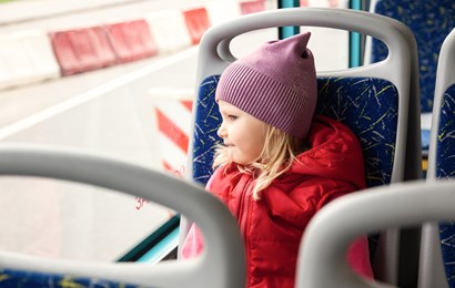 Child Rides Bus At Window Of Public Transport